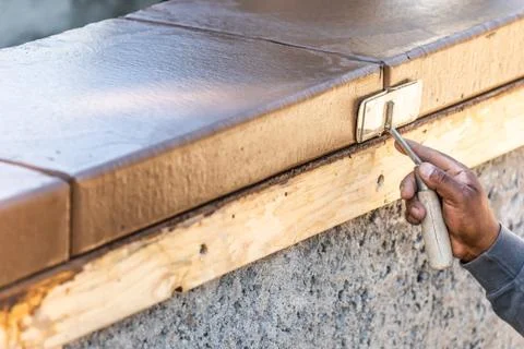 Construction Worker Using Hand Groover On Wet Cement Forming Coping Around Ne Stock Photos
