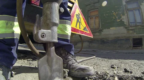 Construction Worker using Jack Hammer Stock Footage