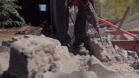 Construction worker using jackhammer demolishing concrete Stock Footage 345551042