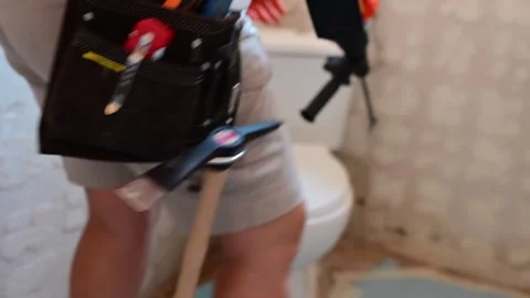 Construction worker using a jackhammer for demolition during a bathroom renovati Video stock 346958778