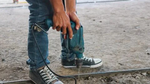 Construction worker using jackhammer drilling concrete surface Stock Photos
