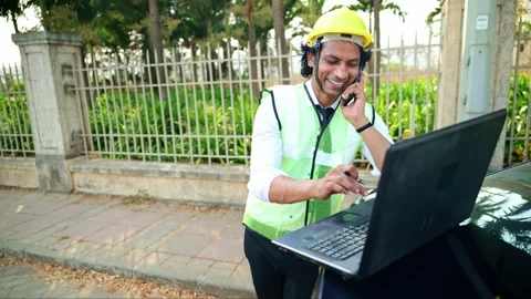 Construction worker using laptop and phone Stock Footage 277036507