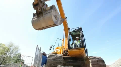 Construction worker using mechanical digger on construction site. 스톡 동영상 11024361