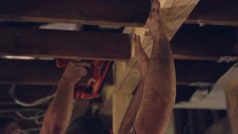 Construction Worker Using Nail Gun Overhead with Help Slow Motion Stock Footage 91761234