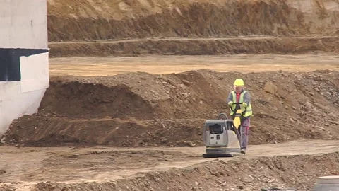 Construction Worker using Plate Compactor Stock Footage 150499980