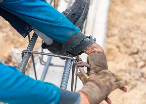 Construction Worker Using Pliers to Tie Steel Reinforcement Bars. Stock Photos