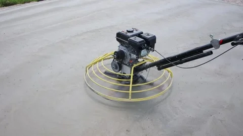 Construction worker using power trowel on concrete surface Stock Footage 315287819