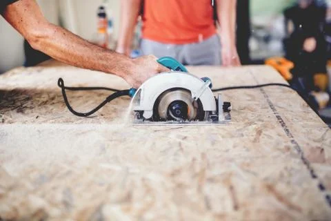 Construction worker using slider compound mitre saw or circular saw Stock Photos