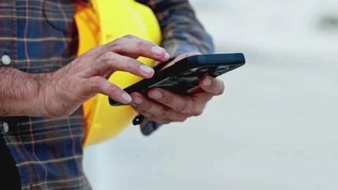 Construction worker using smartphone Stock Footage 220006086