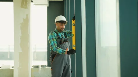 Construction worker using spirit level on window frame Stock Footage 312839775