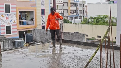 Construction worker using steel rod for checking depth of slab at construction Vídeos de archivo 318001232