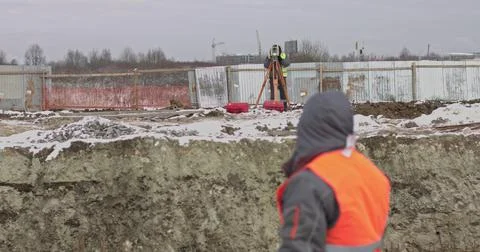 Construction Worker Using Theodolite Surveying Optical Instrument for Measuring Stock Photos
