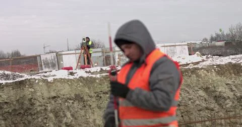 Construction Worker Using Theodolite Surveying Optical Instrument for Measuring Stock Photos