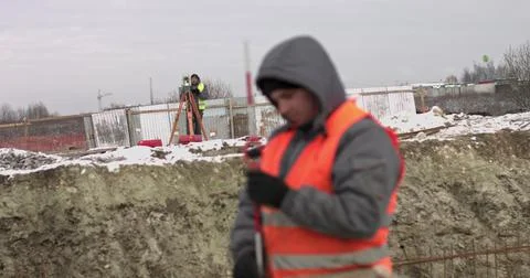Construction Worker Using Theodolite Surveying Optical Instrument for Measuring Stock Photos