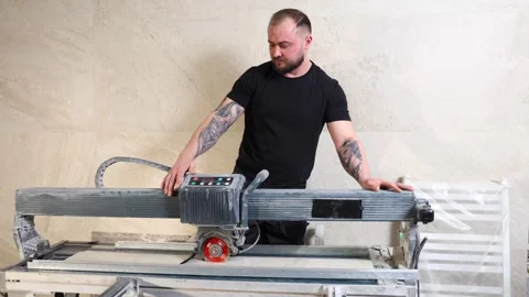 Construction worker using tile saw cutting machine Stock Footage 345680620