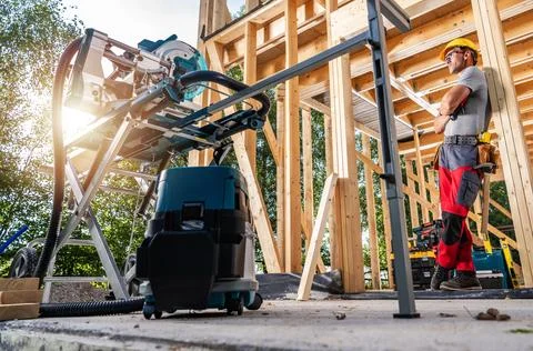 Construction worker using tools in a building site during the day Stock Photos