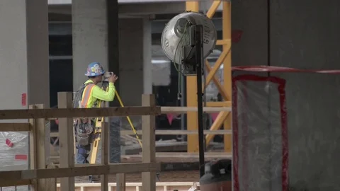 Construction worker using transit level Stock Footage 81414301