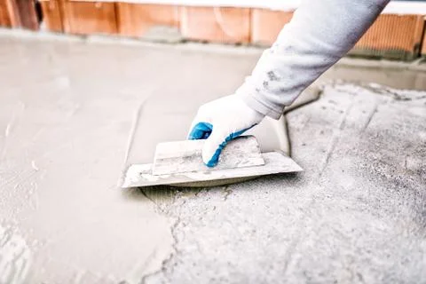 Construction worker using trowel and mason's float for insulating Stock Photos