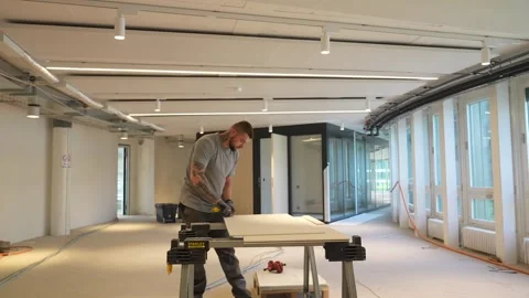 Construction worker using utility knife to cut construction panel on workbench Stock Footage 331305108