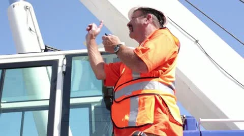 Construction worker using walkie talkie on heavy machinery Stock Footage 11810655