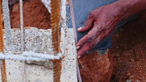Construction Worker Using Water Level Pipe for Foundation Alignment at building Stock Footage 331184397