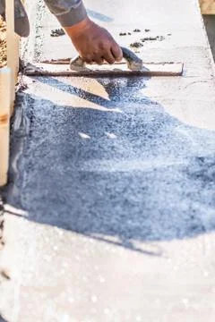 Construction Worker Using Wood Trowel On Wet Cement Forming Coping Around New Stock Photos