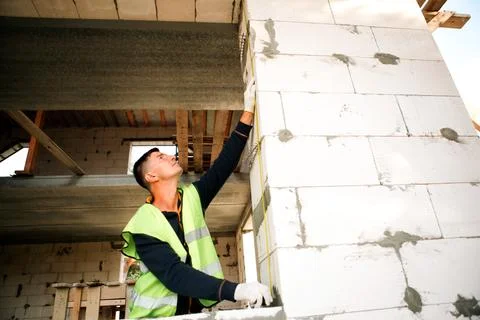 Construction worker verifies ceiling height, measures partition, project pl.. Stock Photos
