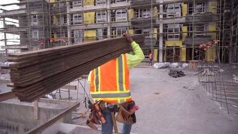 Construction worker walking and working on a construction site Stock Footage 100342320
