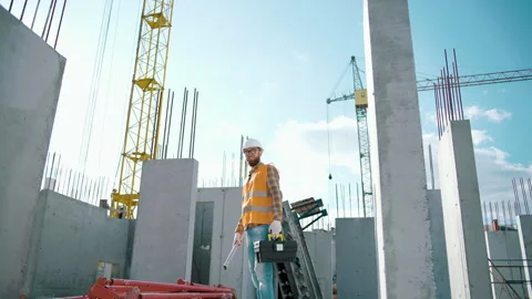 Construction worker walking and working on a construction site Video stock 241173821