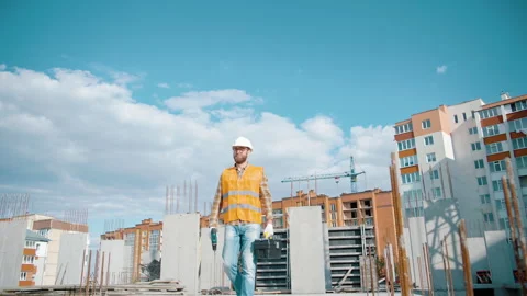 Construction worker walking and working on a construction site with a toolbox Stock Footage 241174545