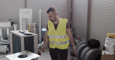 A construction worker walking on the job site and looking for something. Stock Footage 127173905