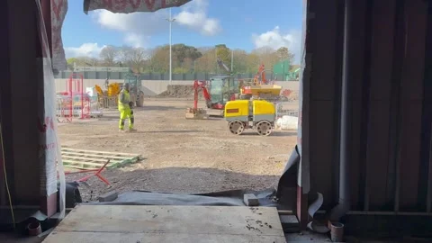 Construction worker walking through active building site Stock-Footage 331464686
