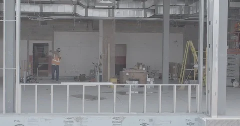 Construction Worker Walking Through Site and Dropping Planks of Wood Stock Footage 101403590