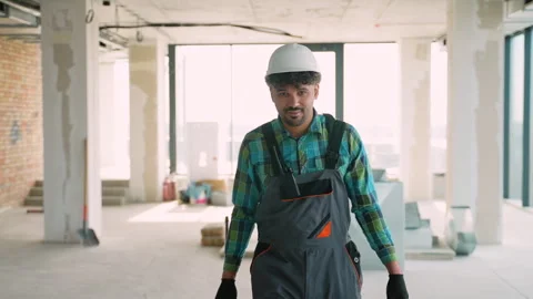 Construction worker walking towards camera in unfinished building Video stock 312840107