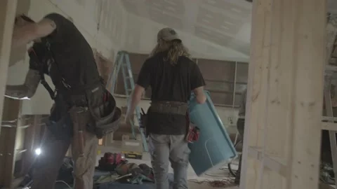 Construction worker walks through a construction site with trash can Stock Footage 144293298