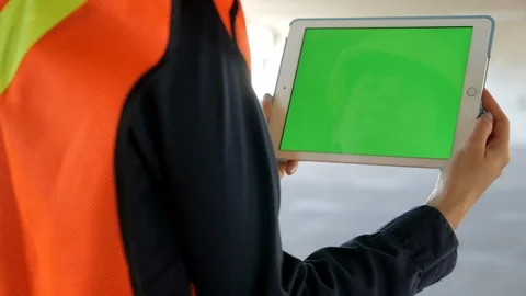 Construction worker watching tablet green screen and swiping, 4k Stock Footage 109465331