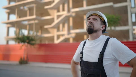 Construction worker wear white safety helmet and work overalls observing pr.. Stock Footage 341332422