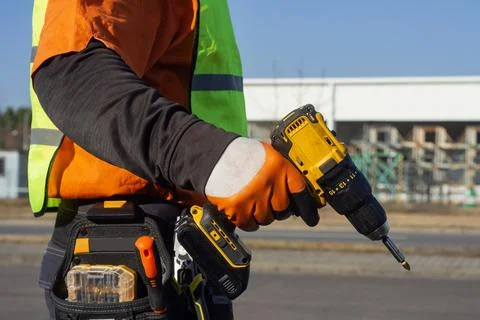 Construction worker wearing a high visibility safety vest and protective glov Stock Photos