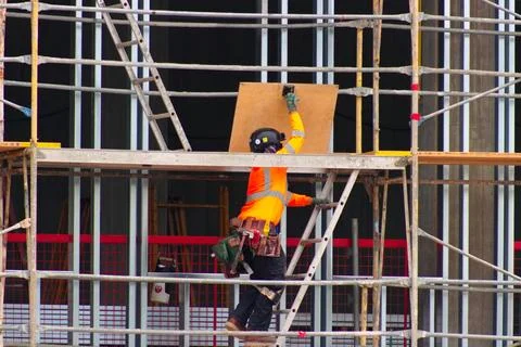 Construction worker wearing high-visibility clothing and protective equipment Stock Photos