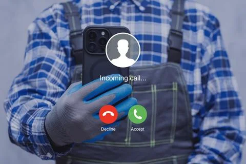 A construction worker wearing protective gloves checks an incoming call on .. Stock Photos