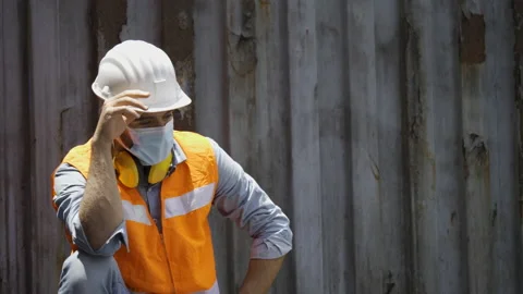 Construction worker wearing safety hardhat And wearing a face mask, Coronavirus  Stock Footage 144861811