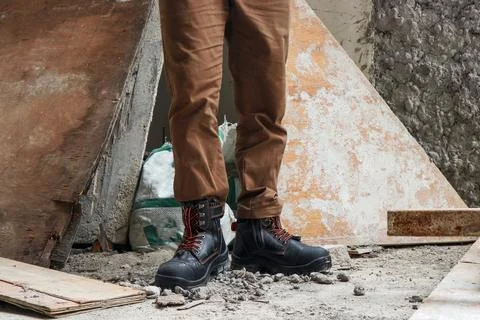 A construction worker wears brown leather boots Stock Photos