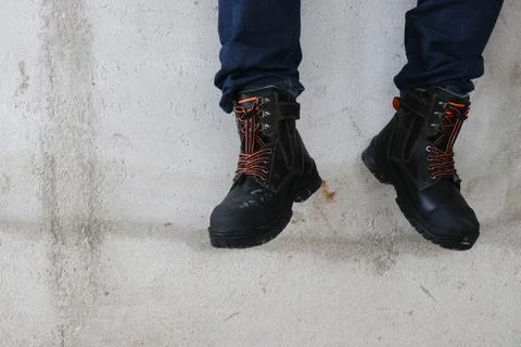 A construction worker wears brown leather boots Stock Photos