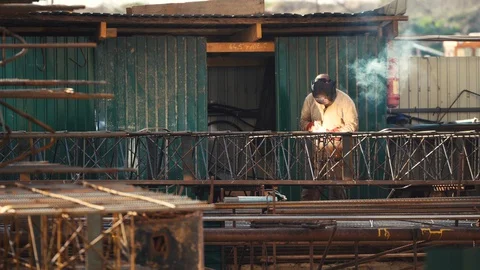 Construction worker welder performs welding work outside Stock Footage 129466014