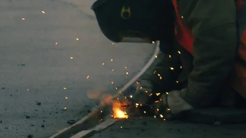 Construction worker welder welding metal outdoors, closeup. Slow motion. Stock Footage 80896373