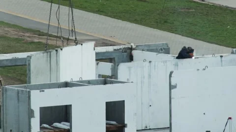Construction worker welding steel elements of precast concrete panel structure Stock Footage 344864370