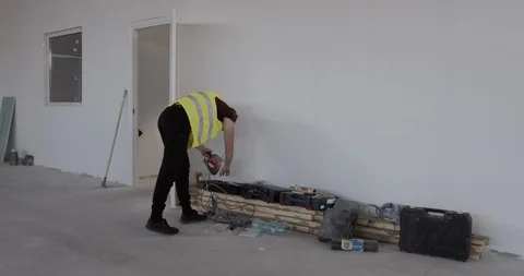 A construction worker while walking on the job site and looking for something. Stock Footage 127175287