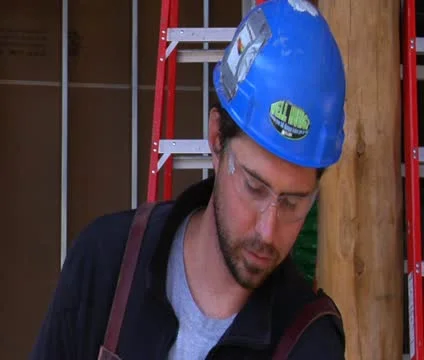 Construction worker wipes brow Stock Footage 21559172