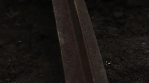 A construction worker in work gloves saws a metal pipe on the ground as spar Stock Footage 132310061
