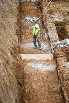 Construction worker working on building foundation Stock Photos